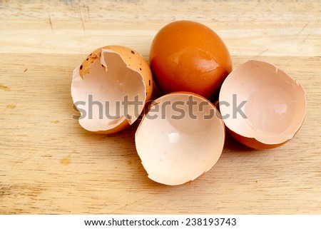 eggs and egg shells on the wooden floor.