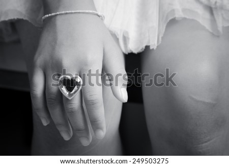 Ring love heart shape inside a young finger  hand in black and white color