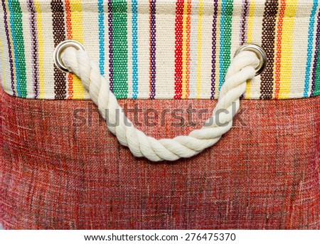 The handle of the bag made of rope woven from yarn.