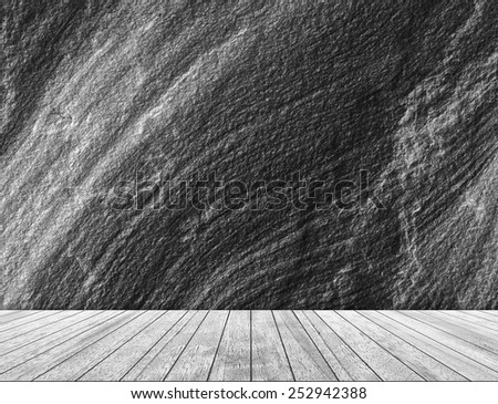 Backdrop black sandstone wall and wood slabs arranged in perspective texture background in black and white.