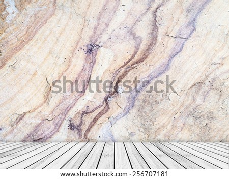 Backdrop natural sandstone wall and white wood slabs arranged in perspective texture background for design.