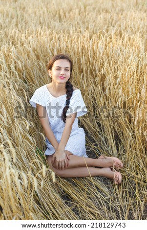 Young  woman in white dress in wheat field. girl in wheat field
