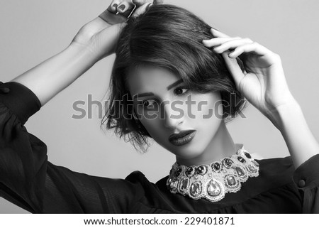 Fashion photo of young magnificent woman. Girl posing. Studio photo. black white