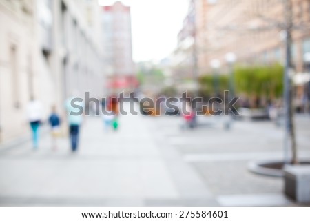 blurred background. people walking on a city street