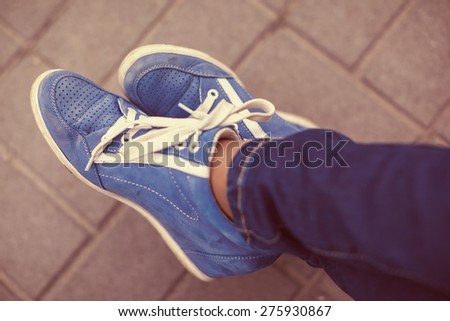 vintage photo of blue shoes standing by street,from above