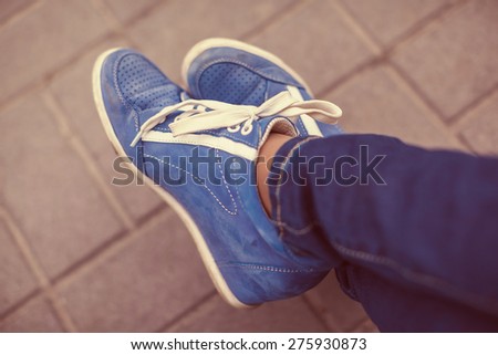 vintage photo of blue shoes standing by street,from above