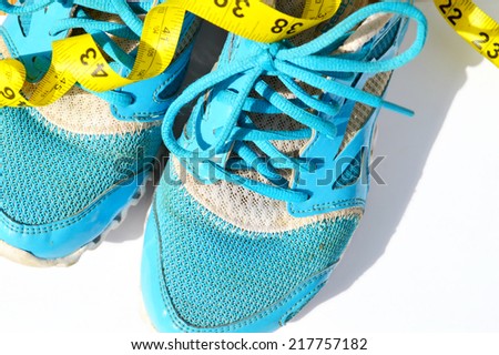 Sport shoes and measuring tape. Fitness concept