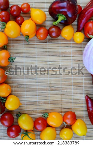 vegetables, healthy food, small red and yellow tomatoes, red pepper, chili, eggplant on a wooden background