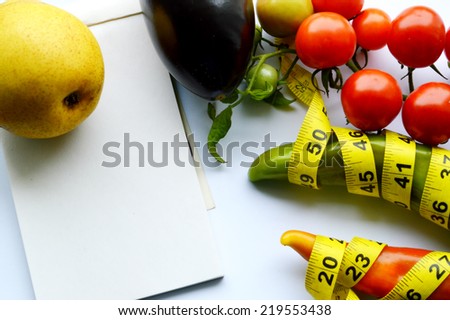 vegetables and fruits for weight loss, a measuring tape, diet, weight loss,cherry tomatoes, green peppers.eggplant