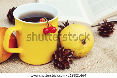 Still life with tea, books,yellow cup