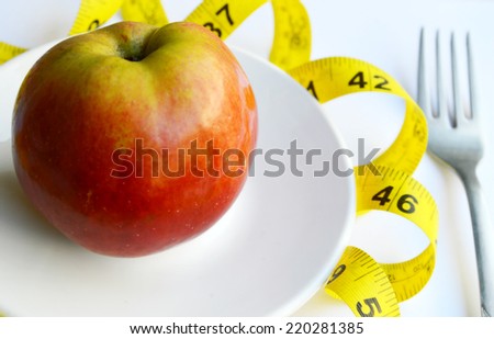 Healthy slimming, red apple,fruits for weight loss, a measuring tape, diet, weight loss