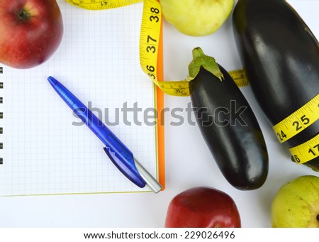 vegetables and fruits for weight loss, a measuring tape, diet, weight loss, measuring tape, healthy eating, healthy lifestyle concept.Notepad,diary,eggplant,Apple,pear