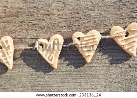 ginger biscuits ,cinnamon,walnuts,hazelnuts on a wooden background .