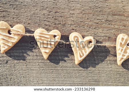 ginger biscuits ,cinnamon,walnuts,hazelnuts on a wooden background .