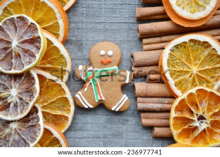 dried oranges, lemons, cinnamon, spice, gingerbread men, Christmas trees, Christmas decorations, closeup on wooden background