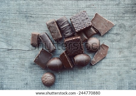 chocolate bar, candy bars,  different chocolate sweets on a wooden background