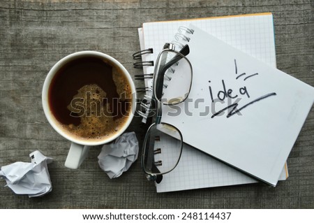Notepad,reading glasses,hot coffee