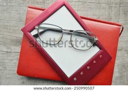 e-book on wooden background.Notepad,diary,record,reading glasses