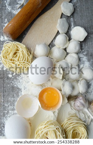 still life with raw homemade pasta and ingredients for pasta..process of cooking pasta.the process of making homemade dumplings,delicious lunch