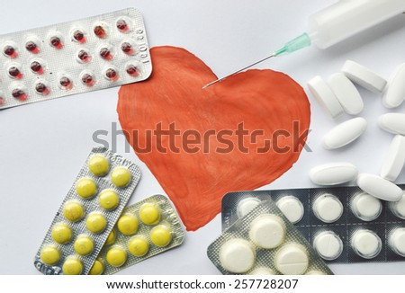 medicine,medicine syringe,pills,health,red heart on a white background,Notepad,writing