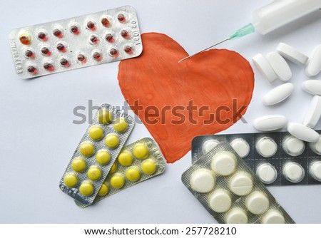 medicine,medicine syringe,pills,health,red heart on a white background,Notepad,writing