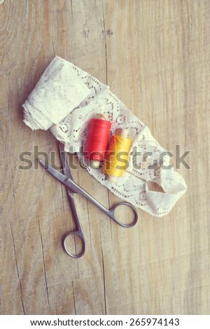 thread for sewing, supplies and accessories for sewing on a light wooden table