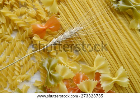 Different types of pasta, macro view on a wooden table