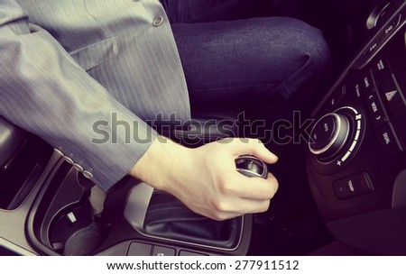 driver hand shifting the gear stick