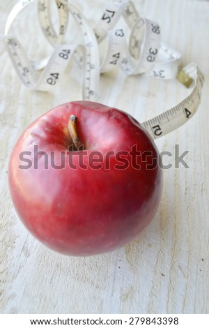 Healthy slimming, red apple,fruits for weight loss, a measuring tape, diet, weight loss