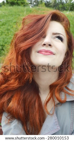 Beautiful young redhead woman smiling with closed eyes, enjoying nature, relaxing, meditating