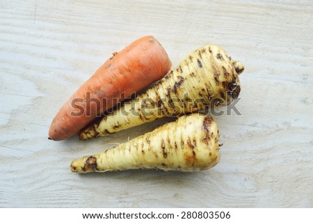 natural, organic vegetables, parsnips, potatoes,carrot, beet, onion, celery knife for cutting vegetables on a wooden table