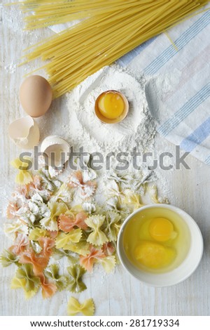 still life with raw homemade pasta and ingredients for pasta..process of cooking pasta