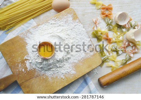 still life with raw homemade pasta and ingredients for pasta..process of cooking pasta