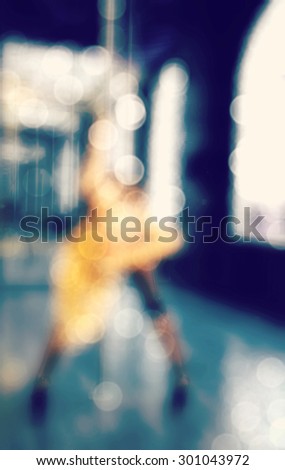 blurred background  of sexy girl dancing on the pylon