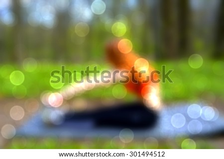athletic, young, girl doing exercises on the nature.lurred background of sporty girl.