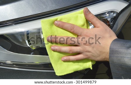 man washing a car with a rag