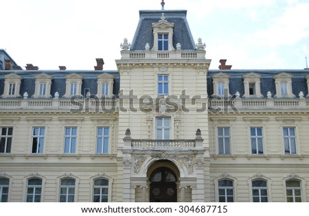 LVIV, UKRAINE - July 9, 2015:Potocki Palace balcony, entrance gates, windows with statues,entrance gates windows with statues, family coat of arms and the patterns on the street Copernicus