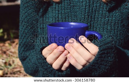 a young ,beautiful girl in the green sweater,holding a hot Cup of coffee,autumn concept,autumn,autumn themes, Cup