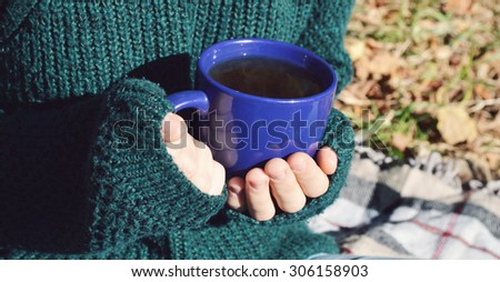 a young ,beautiful girl in the green sweater,holding a hot Cup of coffee,autumn concept,autumn,autumn themes, Cup