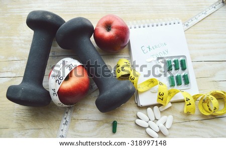 Centimeter and pills.Diet concept. Vitamin pills.Notebook with measuring tap