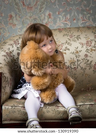 Cute little girl portrait in studio with teddy-bear