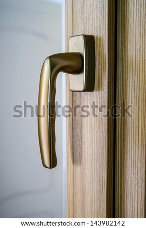 Window handle on fiberglass window. Gold color. Interior design.