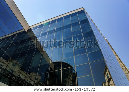 Reflection of Madrid street in modern glass building wall