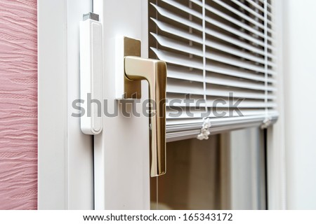 Aluminum blinds on new plastic window with handle