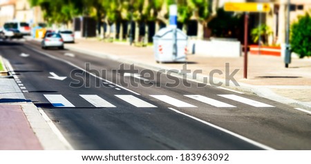 Pedestrian zebra across the street. Tilt shift view.