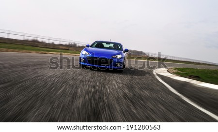 Blue sport car on race way. Motion capture.
