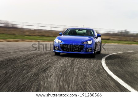 Blue sport car on race way. Motion capture.