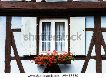 Renovated windows with shutters in village timber-frame house