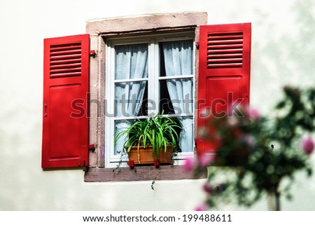 Renovated windows with shutters in village timber-frame house
