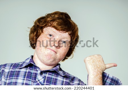Emotional portrait of red-haired boy, attractive for advertising